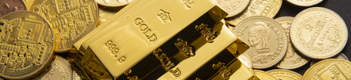 Close up shot of gold coins and bullion bars